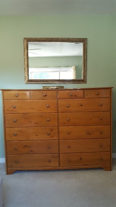 Bedroom set includes large dresser, lingerie chest, bedside table, and queen headboard.