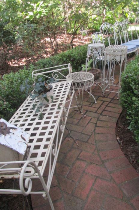 lots of exterior metal furniture, tables and fern stands 