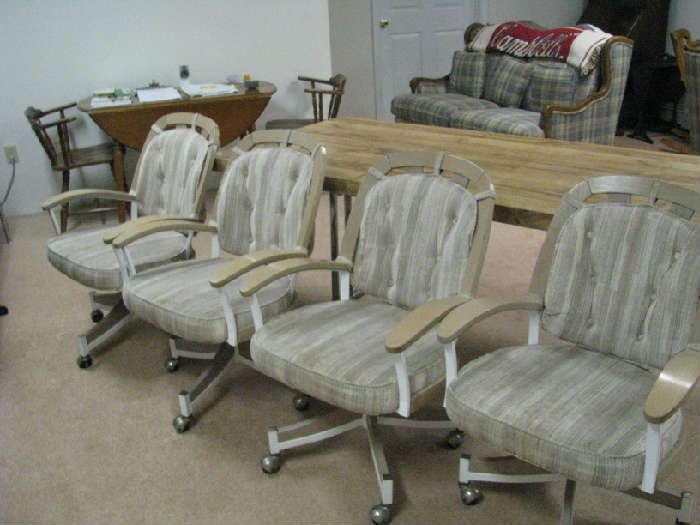 Four padded chairs on wheels. 