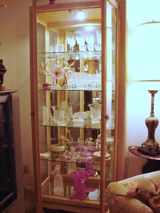 One of two display cabinets filled with glass and porcelain
