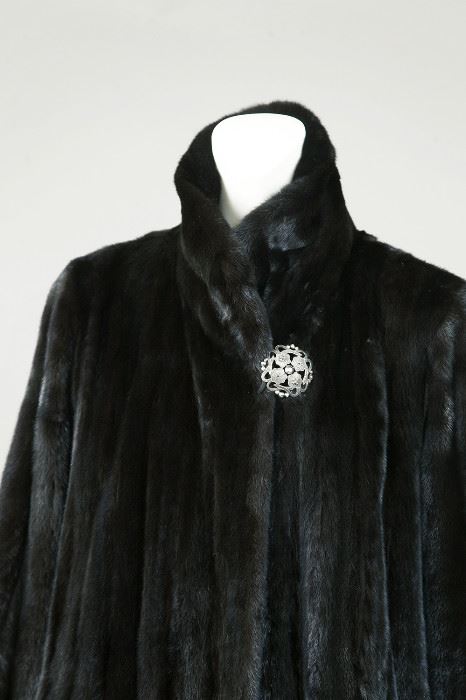 View of the black gamma coat with antique button