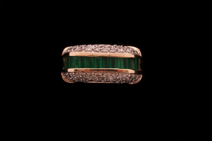 Ladies emerald and diamond ring is large scale. Would look good on a Gent with slender fingers.