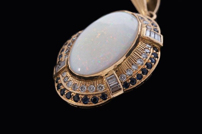 Gorgeous opal pendant is large and impressive. Diamond and sapphire accents. Must see!!