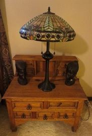Rustic pine side tables, carved heads from Kenya, and Tiffany style lamps