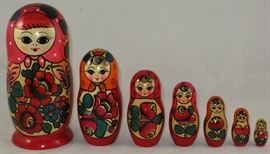Matryoshka Russian Nesting Dolls: Set of 7 hand painted dolls in decreasing size place one inside the other, originally 8 doll set but top of the second doll (not shown) is missing