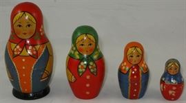 Matryoshka Vintage Russian Peasant Nesting Dolls: A set of 4 hand painted dolls in decreasing size place one inside the other.