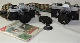 Vintage Canon AE1 35mm Camera with instruction booklet and TX 35mm Canon Camera, both with FD 50mm Lens
