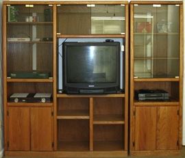 Thornwood Oak Media Entertainment Wall Unit (80"W X 71"H) with lighted (3) upper Glass Front Cabinet shown with a Deluxe Backgammon Set and other various games and puzzle. Also shown is 28" Sony TV and Samsung VHS VCR.