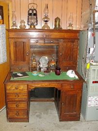1800's Railroad office desk. Picture does this piece no justice. WOW! Exceptional collection of antique oil lamps, very rare, scene in motion Niagra Falls lamp, and Very Rare Dietz Fire House Copper Lantern. 1928 & 1929 Farragut High School leather year books, 1950's Art Deco lighted makeup mirror.