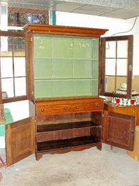 Pegged adjustable shelves, hand chamferd door panels, 12 pane wavy glass, original key & locks, three board back.