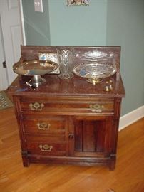 Oak wash stand with marble top, early American pressed glass pitcher and cake plates, silverplated cake plants, English tiles, and more