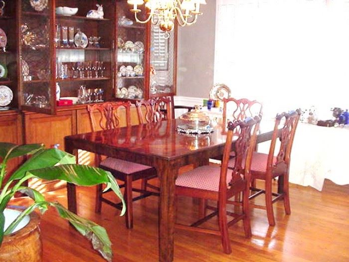 Dining table and eight Chippendale style chairs, table has several leaves and pads