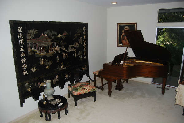baby grand Mathushek piano, antique Chinese tables and screen