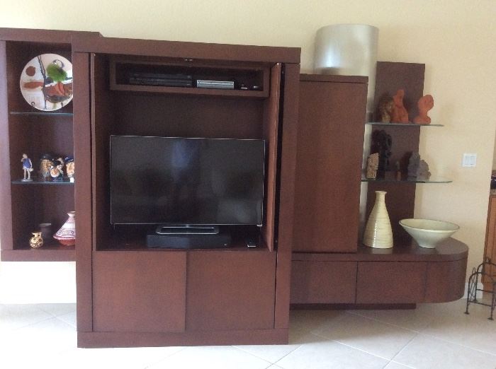 Modern entertainment piece with doors, drawers and glass shelves