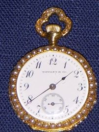 The Tiffany 18k watch with pearls and diamonds.  This watch is about 1" diameter