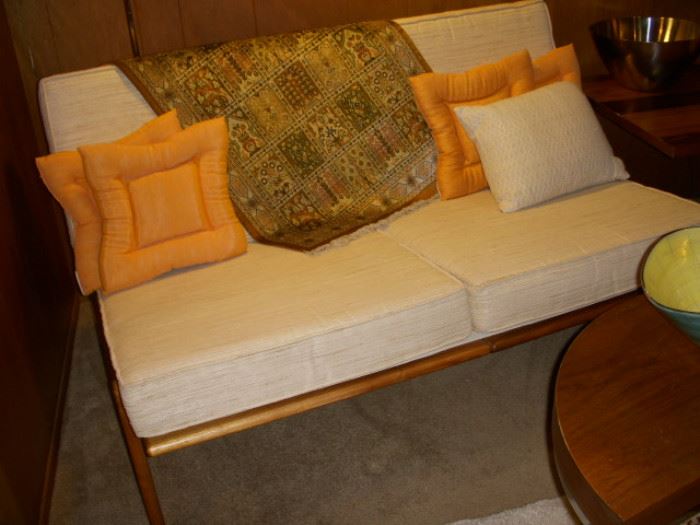 Danish Modern loveseat.  Woven silk rug displayed between pillows