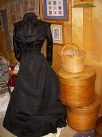 Victorian dress, Stack of cheese boxes, etc.  On wall, are framed mini quilts