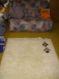 Twin size futon, along with area rug