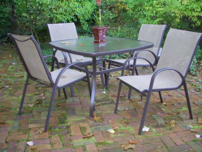 Patio table & chair set.  Table top is pebbled glass