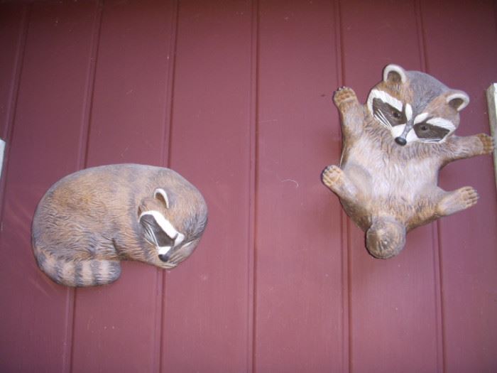 Ceramic racoon wall decorations outside