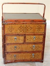 Chinese Handpainted Medicine Box

To top of handle, stands 24"tall x 17"wide x 11 1/2"deep. Handcrafted and handpainted. Intricate scroll design on top and on the wicker. 8 drawers, 4 on each side. 