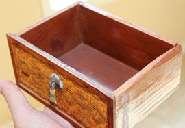 Chinese Handpainted Medicine Box

To top of handle, stands 24"tall x 17"wide x 11 1/2"deep. Handcrafted and handpainted. Intricate scroll design on top and on the wicker. 8 drawers, 4 on each side. 