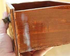 Chinese Handpainted Medicine Box

To top of handle, stands 24"tall x 17"wide x 11 1/2"deep. Handcrafted and handpainted. Intricate scroll design on top and on the wicker. 8 drawers, 4 on each side. 