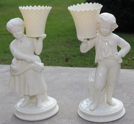 Belleek Irish Porcelain Basket Bearer Boy and Girl Mantle Candle Holders

Each measure 8 1/2"tall. A fabulous pair of Belleek Ireland spill vase parian china figurines. All Belleek porcelain is crafted and painted entirely by hand, with love and care, at the Belleek Studio, County Fermanagh, Ireland. Beautiful cream glaze parian china, 18th century dressed Welsh boy and girl holding a weave basket spill vase, perfect mantel figurines.