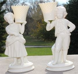 Belleek Irish Porcelain Basket Bearer Boy and Girl Mantle Candle Holders

Each measure 8 1/2"tall. A fabulous pair of Belleek Ireland spill vase parian china figurines. All Belleek porcelain is crafted and painted entirely by hand, with love and care, at the Belleek Studio, County Fermanagh, Ireland. Beautiful cream glaze parian china, 18th century dressed Welsh boy and girl holding a weave basket spill vase, perfect mantel figurines.