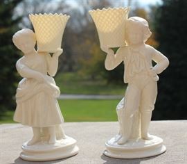 Belleek Irish Porcelain Basket Bearer Boy and Girl Mantle Candle Holders

Each measure 8 1/2"tall. A fabulous pair of Belleek Ireland spill vase parian china figurines. All Belleek porcelain is crafted and painted entirely by hand, with love and care, at the Belleek Studio, County Fermanagh, Ireland. Beautiful cream glaze parian china, 18th century dressed Welsh boy and girl holding a weave basket spill vase, perfect mantel figurines.