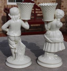 Belleek Irish Porcelain Basket Bearer Boy and Girl Mantle Candle Holders

Each measure 8 1/2"tall. A fabulous pair of Belleek Ireland spill vase parian china figurines. All Belleek porcelain is crafted and painted entirely by hand, with love and care, at the Belleek Studio, County Fermanagh, Ireland. Beautiful cream glaze parian china, 18th century dressed Welsh boy and girl holding a weave basket spill vase, perfect mantel figurines.