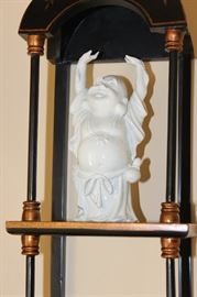 Buddha Stand

Pretty Asian-themed wall hanging, 3-shelved unit with Buddha figurine and vase as shown in pictures. Measures 46"tall x 9 1/2"wide x 7 1/2"deep. Buddha figurine is 9 1/2"tall. Overall very good condition. Black painted with copper-toned trim. No identifying markings on the Buddha figure. 