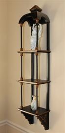 Buddha Stand

Pretty Asian-themed wall hanging, 3-shelved unit with Buddha figurine and vase as shown in pictures. Measures 46"tall x 9 1/2"wide x 7 1/2"deep. Buddha figurine is 9 1/2"tall. Overall very good condition. Black painted with copper-toned trim. No identifying markings on the Buddha figure. 