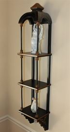 Buddha Stand

Pretty Asian-themed wall hanging, 3-shelved unit with Buddha figurine and vase as shown in pictures. Measures 46"tall x 9 1/2"wide x 7 1/2"deep. Buddha figurine is 9 1/2"tall. Overall very good condition. Black painted with copper-toned trim. No identifying markings on the Buddha figure. 