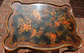 Beautiful Handpainted Side Table

Japanned. Measures 24"tall x 38"wide x 29"deep. Handpainted by: Maitland-Smith LTD. Small sticker on bottom reads: Handmade in Phillipines. Another sticker has written on it: 2543-220. Very beautiful, has pad feet and floral design top with birds. 