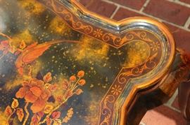 Beautiful Handpainted Side Table

Japanned. Measures 24"tall x 38"wide x 29"deep. Handpainted by: Maitland-Smith LTD. Small sticker on bottom reads: Handmade in Phillipines. Another sticker has written on it: 2543-220. Very beautiful, has pad feet and floral design top with birds. 