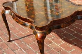 Beautiful Handpainted Side Table

Japanned. Measures 24"tall x 38"wide x 29"deep. Handpainted by: Maitland-Smith LTD. Small sticker on bottom reads: Handmade in Phillipines. Another sticker has written on it: 2543-220. Very beautiful, has pad feet and floral design top with birds. 