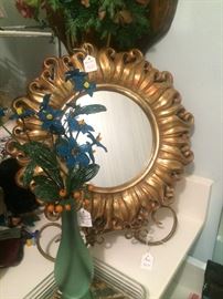 Round gold mirror; beaded floral arrangement