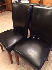 Four black parson's chairs