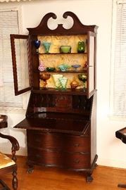Mahogany secretary showing vintage glass.