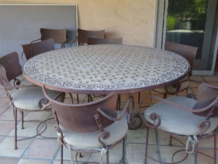 Tiled outdoor table and eight chairs; multiple suitcases and travel accessories