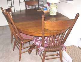 Antique round oak table with two leaves and pedestal base. 