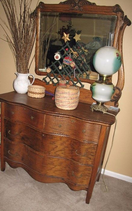 Nice antique serpentine front four drawer dresser with fancy beveled mirror.