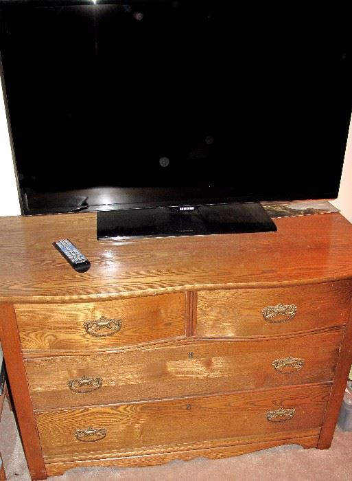 Antique golden oak four drawer dresser. Samsung 40" tv.