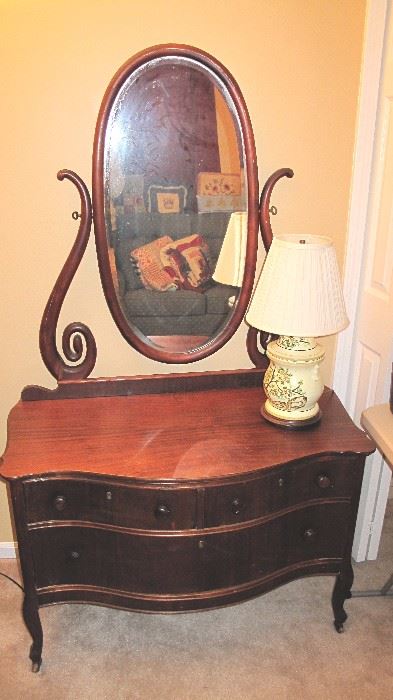 Nice mahogany two drawer with oval beveled mirror.