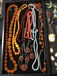 Coral, amber, carne beads, jewelery from the flapper era, cameos, semi precious jewelery, enameled pins more