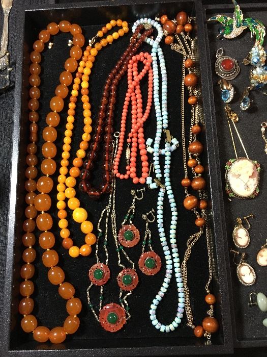 Coral, amber, carne beads, jewelery from the flapper era, cameos, semi precious jewelery, enameled pins more