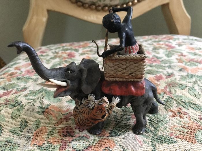 Miniature hand painted bronze Native on elephant fending off tiger in the style of Bergmann