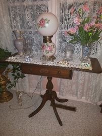 Drop leaf pedestal table, hurricane lamp, crystal, & more. 