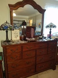 Large dresser with mirror, stained glass lamps, jewelry box, costume jewelry, & more. 